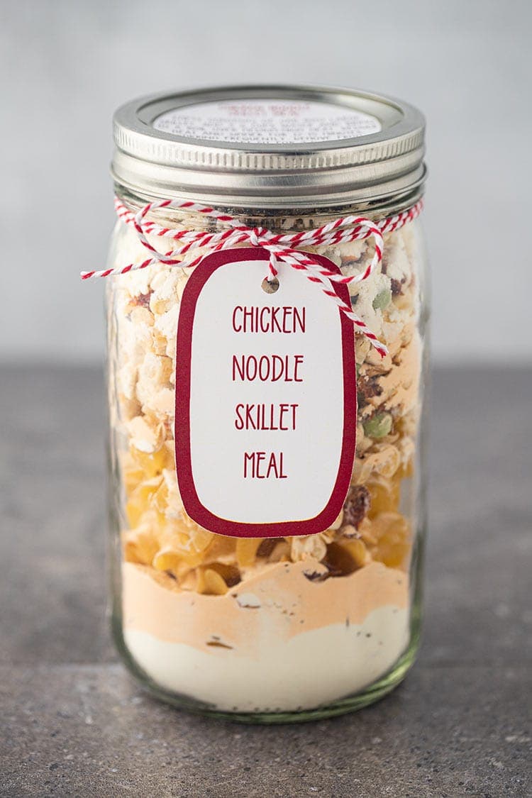 Picture of Chicken Noodle Skillet Meal in a Jar sitting on a gray countertop with label and gift tag.