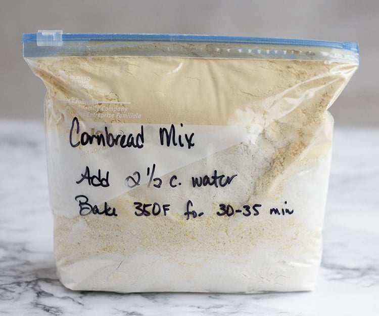 Bag of cornbread mix sitting on counter, with instructions written on front.