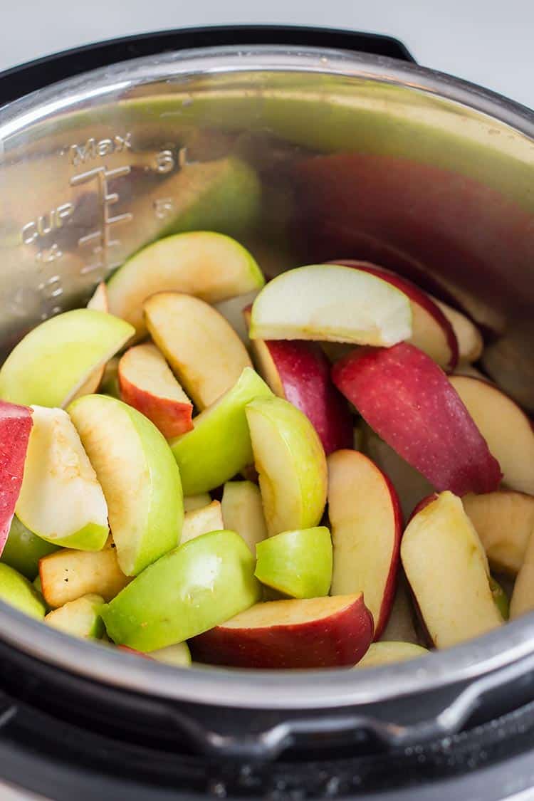 Prepared apples with peels left on, in the cooking pot of the Instant Pot pressure cooker