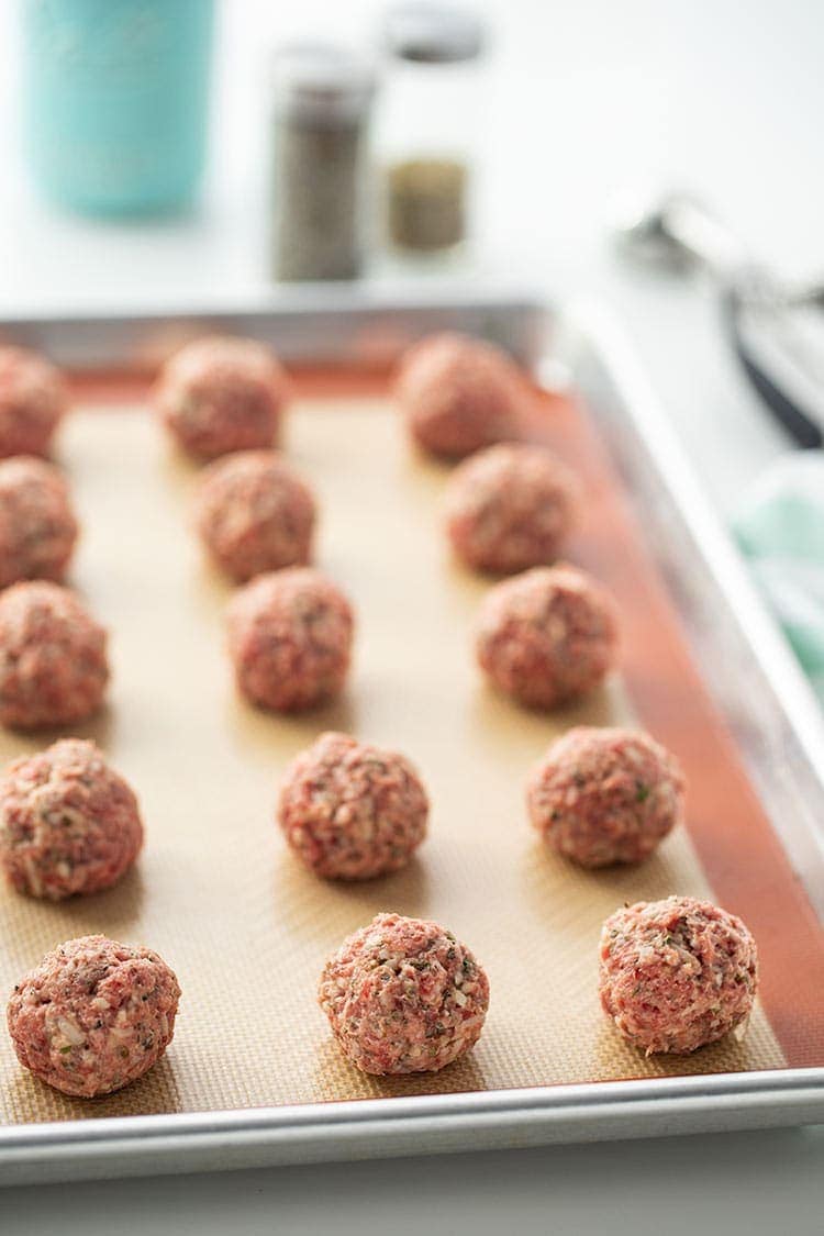 Easy Keto Meatballs portioned out on a baking sheet and ready to bake