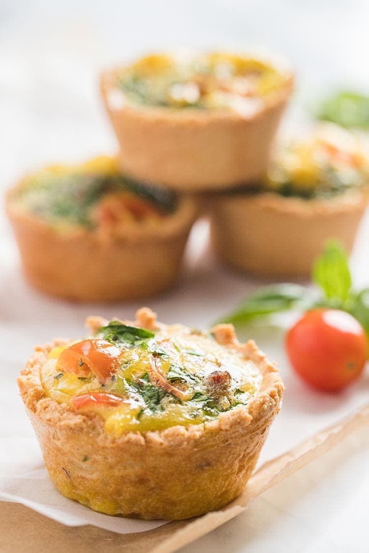LowCarb Mini Quiches with Almond Flour Crust stacked on the counter