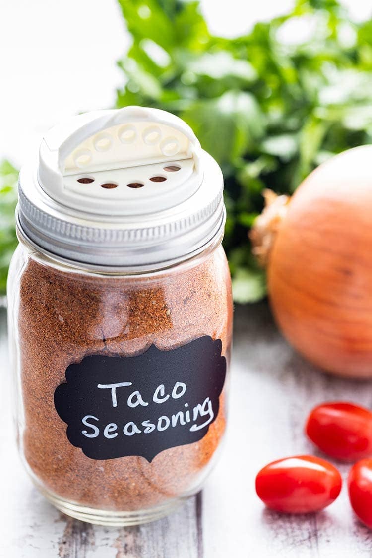 Taco seasoning mix in a pint-size mason jar with a chalkboard label on the front and a shaker lid on top