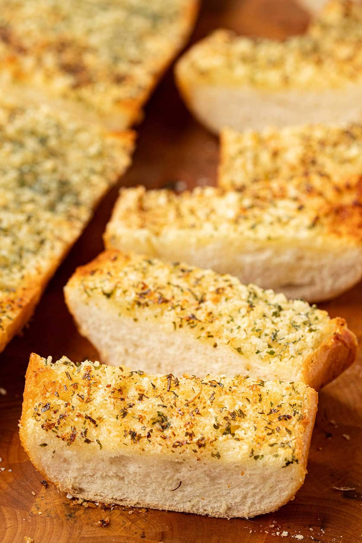 A closeup shot of slices of make-ahead freezer garlic bread on a cutting board.