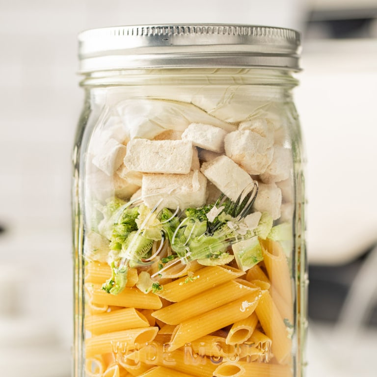 Close up shot of Chicken Broccoli Alfredo Meal in a Jar as sealed in the jar for storage.